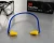 3M Caboflex banded earplugs with yellow tips and blue band on a work surface with safety glasses
