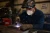 Welder wearing a disposable welding respirator mask while working with metal in an industrial fabrication