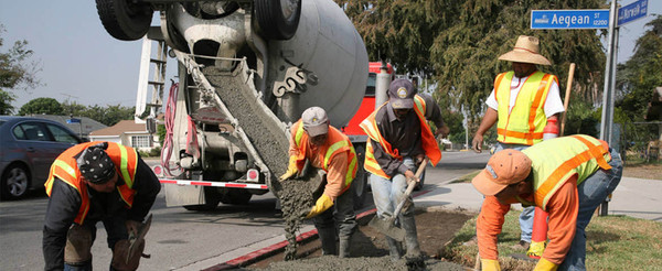 Construction workers wearing high-visibility personal protective equipment