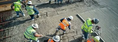 Construction workers wearing high-visibility personal protective equipment
