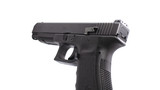 Close up photo of Primatia Raised and Extended Slide Release showing it installed on the pistol, angled view