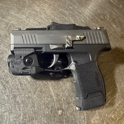 Sig P365 with Raised and Extended slide release installed, raw stainless steel finish