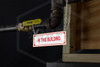 In This Building Sign | 6 in. x 2 in. | White w/ Red Letters | Installed