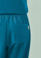 A pair of women's jogger scrub pants in teal with an elastic waistband and a side pocket.