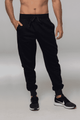 Tapered fleece men's pants in black, featuring an elastic waistband and side pockets. Includes a logo on the garment.