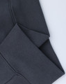 A close-up of grey oversized fleece hoodie cuffs with a textured ribbed finish and visible stitching.