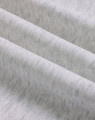 A close-up of soft, grey fabric showing a textured, fleece surface with subtle variations.