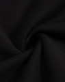A close-up view of black fleece fabric, showcasing its soft texture and smooth finish.