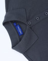 A dark grey ladies' classic cotton/poly pique short sleeve polo featuring a collar and button detail with a tag.