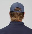 A navy blue cotton twill unstructured cap with an adjustable strap at the back, seen from the rear.