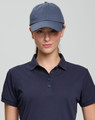 A navy cotton twill unstructured cap worn by a model, featuring a logo on the front.
