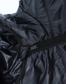 A close-up of a lightweight hooded puffer jacket in black, showcasing its zipper and inner lining.