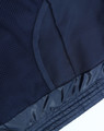 A navy kids' sustainable lightweight hooded puffer jacket featuring a textured interior and smooth exterior finish, with a logo.