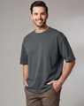 A unisex heavy cotton oversized tee in slate grey, featuring a relaxed fit and short sleeves, with a logo present.