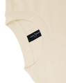 A beige unisex heavy cotton oversized tee featuring a label on the sleeve.
