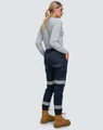 Cotton stretch drill cuffed work pants in navy with reflective tapes, worn with a grey long-sleeve top and boots.