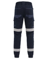 Cuffed work pants in navy with reflective tape and multiple pockets. Features an elastic waistband at the back.