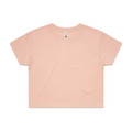 A cropped tee in a soft peach colour with a relaxed fit and short sleeves. It features a branding label.