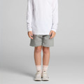 Kids stadium shorts in grey, featuring an elastic waistband and a logo, styled with a long-sleeve white top and sneakers.