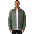 A man wearing a green service jacket over a white t-shirt, standing with a neutral expression. The jacket has a logo.