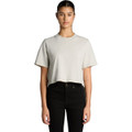 A cropped, heavy faded t-shirt in light grey, displayed on a model with black jeans. The shirt has a logo.