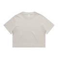 A light beige cropped t-shirt featuring short sleeves and a round neckline. The shirt has a simple design and a logo.