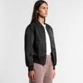 A black varsity bomber jacket worn by a model, featuring a front snap closure and ribbed cuffs.