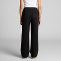 Cuffless black track pants with a relaxed fit and a back pocket, showcased on a model from the rear.