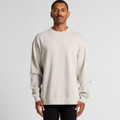 A beige crew jumper featuring long sleeves and a relaxed fit, displayed on a model against a neutral backdrop.