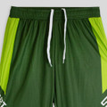 Green active pants with bright green accents, featuring a white drawstring and a logo. Ideal for sports or workouts.