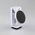 A white mobile phone stand featuring a round black base and adjustable arm for supporting devices.