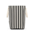 A striped tote bag in black and cream with two handles and a logo on the side.