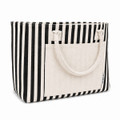 A striped tote bag with black and cream colours, featuring a front pocket and two top handles.