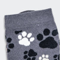 Grey knitted kids' socks featuring a playful pattern of black and white paw prints.