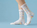 Custom branded cycling socks in white with colourful patterns and a logo, designed for comfort and style.