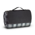 A Colorado Picnic Blanket, rolled up and secured with a black handle, showcasing a plaid pattern in gray and white.