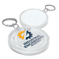 A circular clear key ring featuring a maze design and a logo, with a silver metal keychain attachment.