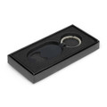 A drink bottle opener key ring in black, presented in a sleek black box with a foam insert.