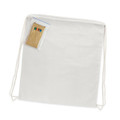 A cotton drawstring backpack in a plain white color, accompanied by a small package containing coloring materials.