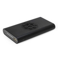 A black wireless power bank featuring a circular control panel and USB ports. It has a sleek, minimalist design.