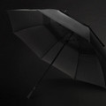 A 76cm black storm umbrella with a sturdy frame and a handle, featuring a branded logo.