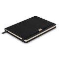 A black notebook with a textured cover, featuring a ribbon bookmark and a branding logo on the front.