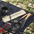 A stainless steel cutlery set with wooden handles, including a spoon, fork, knife, and straw, in a cloth pouch.