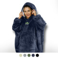 A woman wearing a navy blue hoodie blanket with a large hood and a front pocket, featuring a logo.