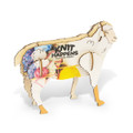 A wooden model of a sheep with colourful yarn decorations, featuring a logo on its side.
