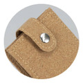 A cork manicure set with a snap closure, featuring a natural beige tone and textured finish. It has a logo.