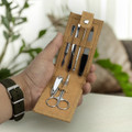A cork manicure set featuring silver tools including scissors, nail clippers, and a file, housed in a tan pouch.