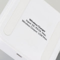 A wireless charging stand in white with a smooth surface and a branding logo on the base.