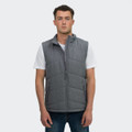 A grey puffer vest displayed on a model wearing a white T-shirt and jeans. The vest features a branding logo.