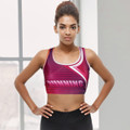 A women's athletic crop top in shades of pink and purple with a logo, featuring a sporty design.